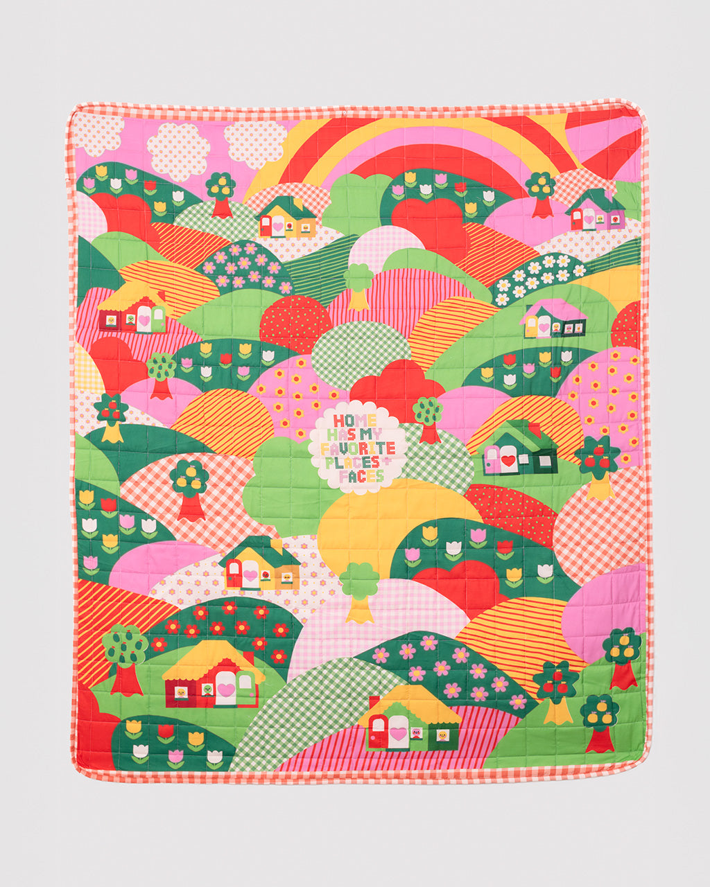 quilted blanket with colorful ill and house print with 'house has my favorite places and faces' typography in the center