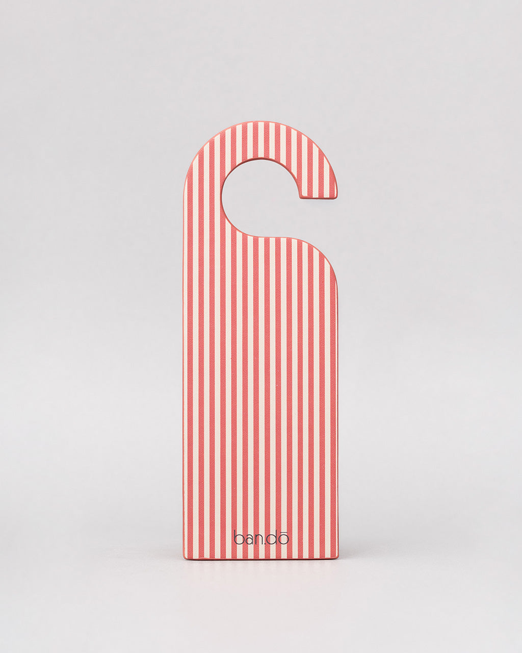 back pink and white vertical stripe of pink bookmark in the shape of a door hanger with white 'do not disturb! book reading in progress' across the front