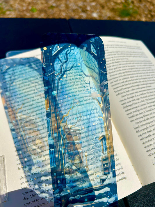 Snowy winter library bookmark with glowing bookshelves, enchanted trees, and magical snowfall through a gothic window