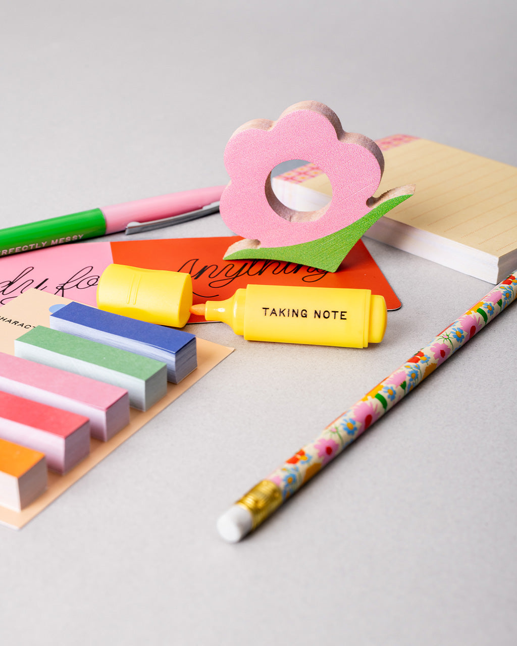 up close of reading kit with 5 sticky flags (75 sheets each), mini highlighter, sticky notepad (75 sheets), book holder, bookmark, pencil, pen