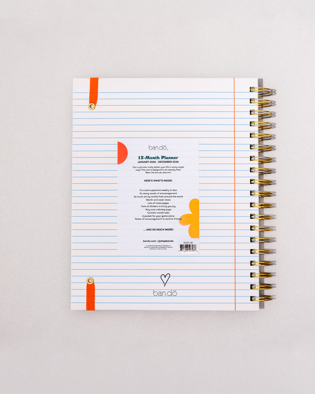 back view of white lined paper large 12-month planner with cursive 'ready for anything' font and orange elastic closure