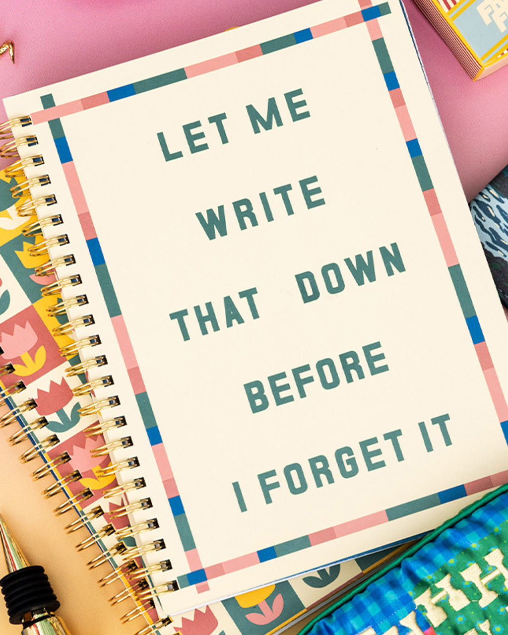 cream mini notebook with colorful striped border and teal 'let me write that down before i forget it' on a tulip print notebook